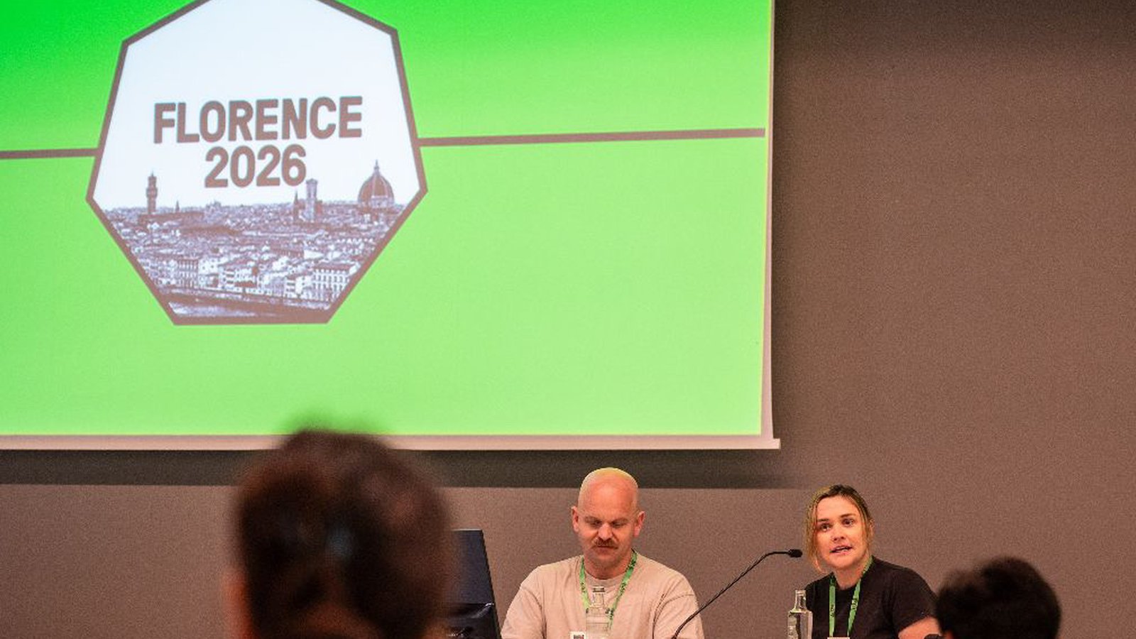 Harriet Goodrich and Barrett Wolfe chairing a session under the Florence 2026 conference logo